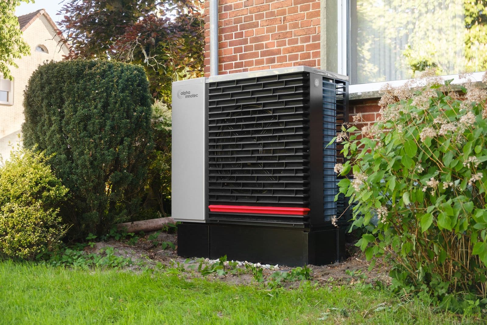 Residential outdoor heat pump condenser unit installed next to a Southern California home